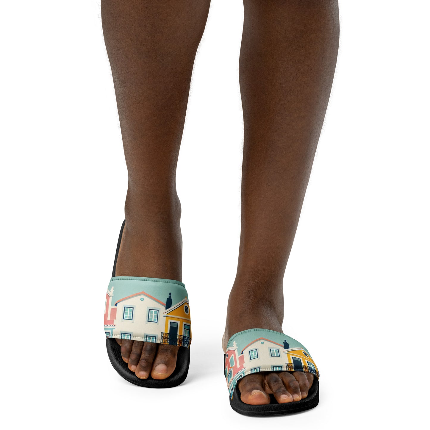 Close-up of feet wearing Alfama Woman Pool Slippers with a Portuguese-inspired colorful house pattern. Perfect for casual and poolside wear.
