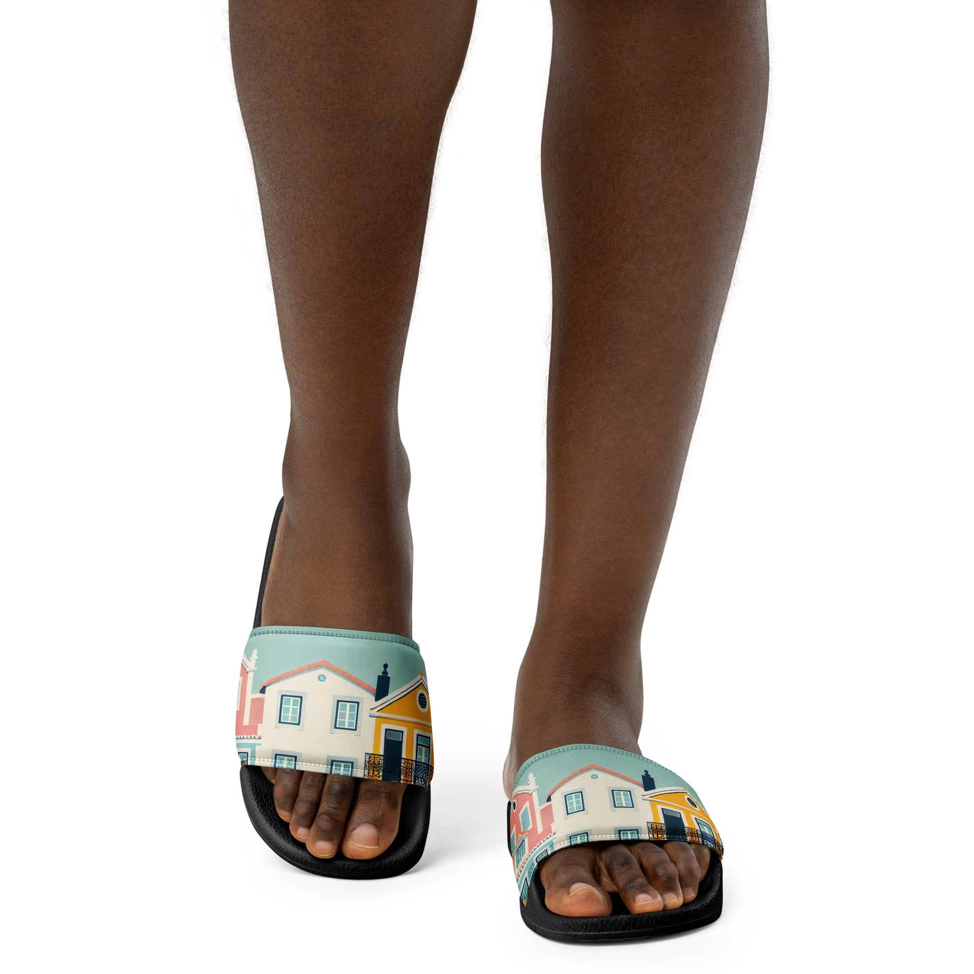 Close-up of feet wearing Alfama Woman Pool Slippers with a Portuguese-inspired colorful house pattern. Perfect for casual and poolside wear.
